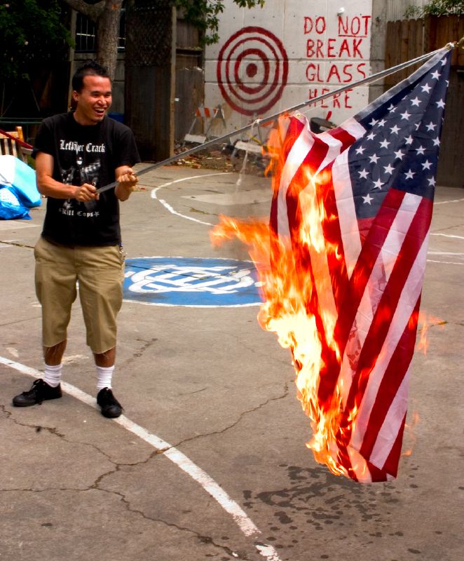 A man burning the American flag.
