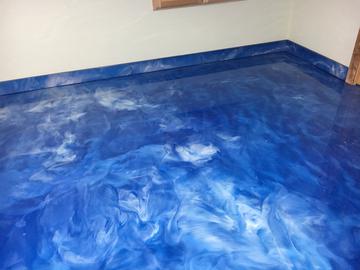 blue epoxy floor with matching baseboards